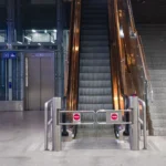 A modern indoor escalator and elevators in a public space, showcasing urban architecture.
