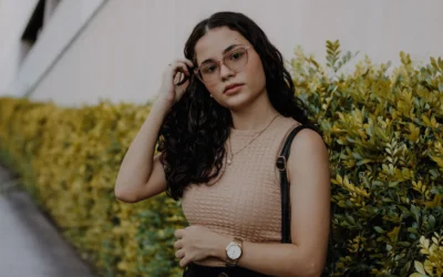 Portrait of a stylish woman with glasses standing by foliage in Nova Iguaçu, Brazil.